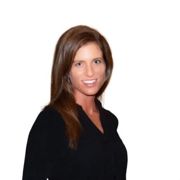 A woman in black shirt smiling for the camera.